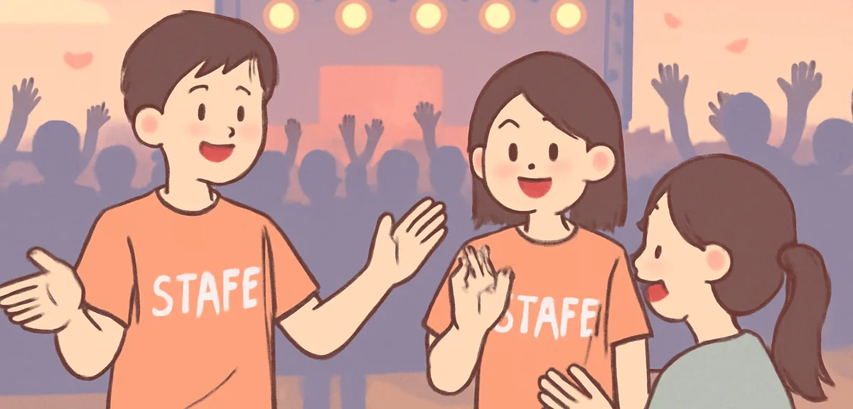 Young Japanese people in staff T-shirts helping guests at a large summer outdoor concert venue at du